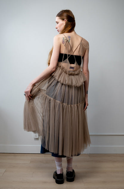 Back view of Georgia tulle dress in a soft beige tone with delicate tiers and a ethereal drape from the core collection.