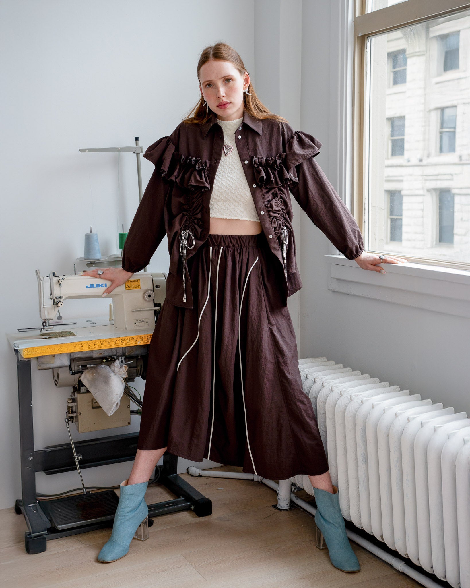 Model wearing the Riley Shirt with the built-in adjustable cords cinched for a fitted silhouette.