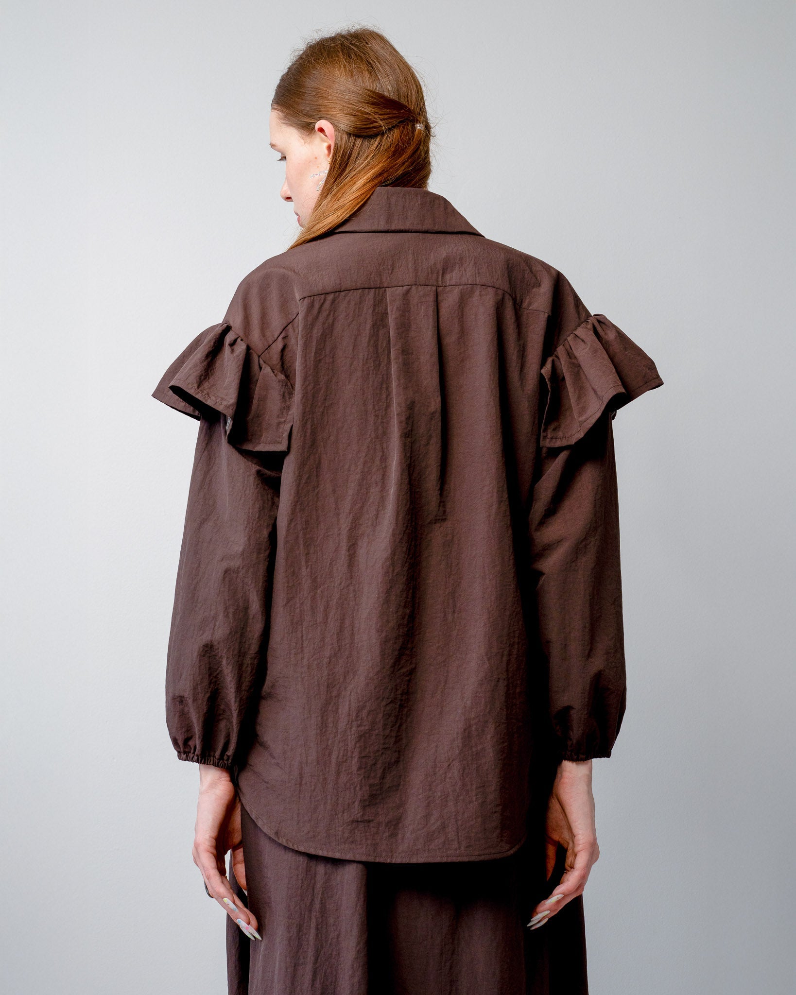 Back view of the whimsical ruffle placement and easy-care nylon fabric on the Riley Shirt.